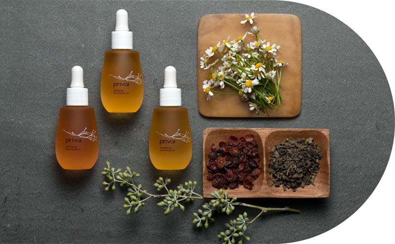 Privai Products laid out with herbs and floral pieces