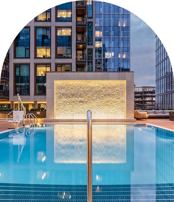 Pool Management done by Arch Amenity Group with a glowing pool in a city setting