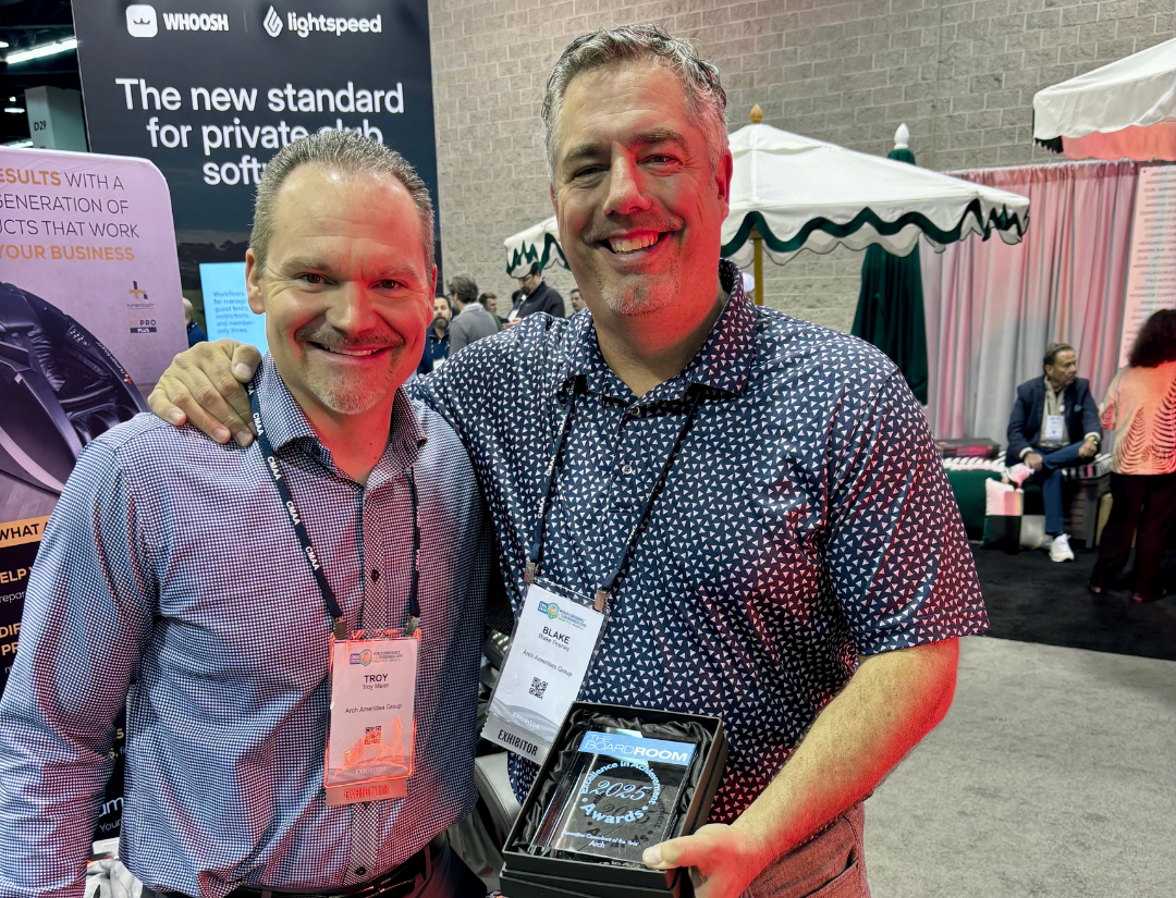 Two Arch employees with a 2025 award in hand.